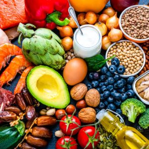 Overhead view of a large group of healthy raw food for flexitarian mediterranean diet. The composition includes salmon, chicken breast, canned tuna, cow steak,  fruits, vegetables, nuts, seeds, dairi products, olive oil, eggs and legumes. High resolution 42Mp studio digital capture taken with SONY A7rII and Zeiss Batis 40mm F2.0 CF lens